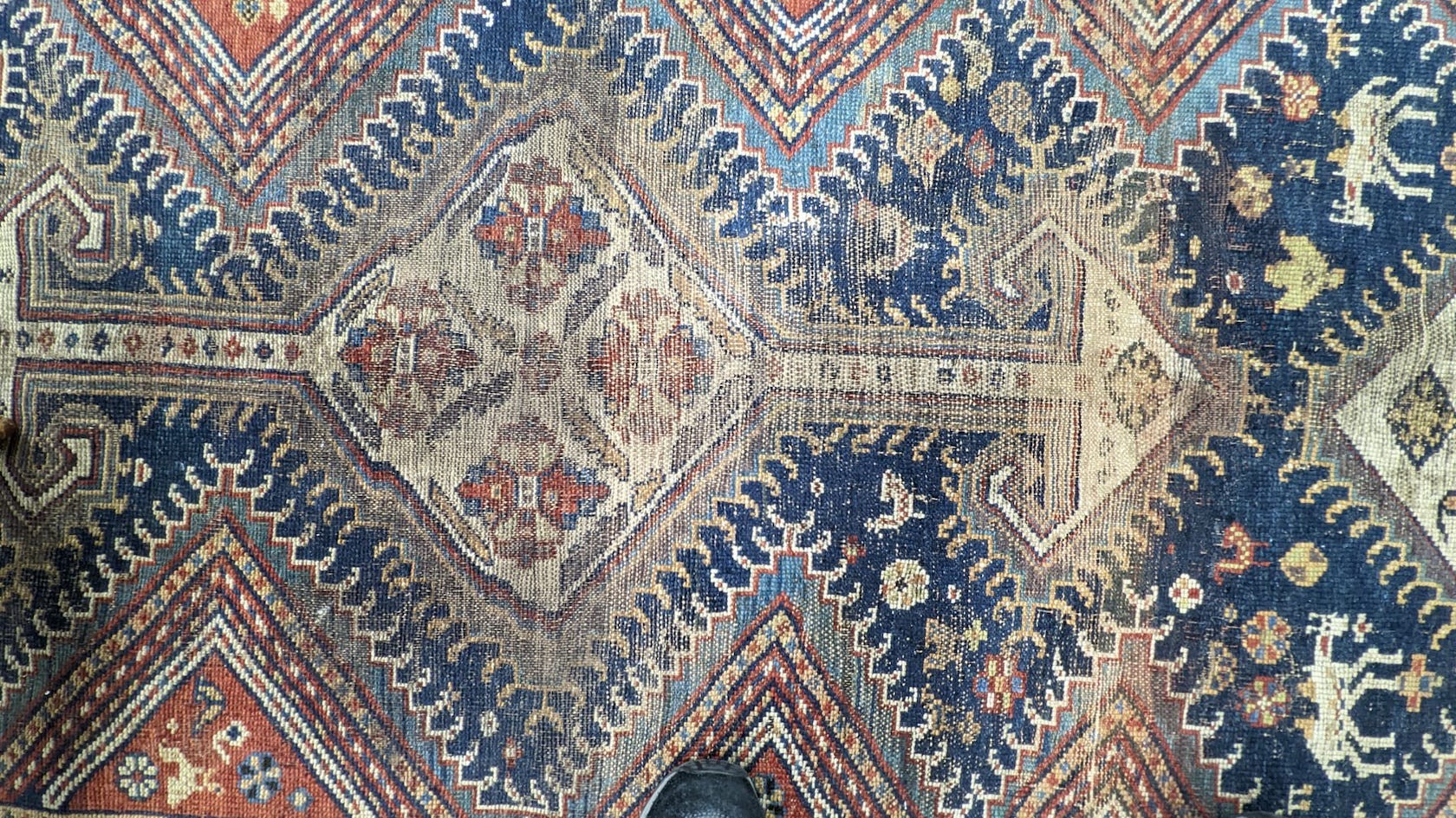 A pair of antique Caucasian blue ground rugs, 290 x 132cm